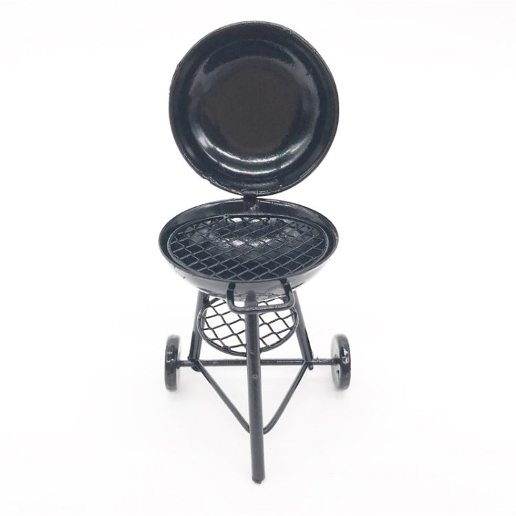 Mini round outdoor oven toy with open lid and tripod stand, dark metal