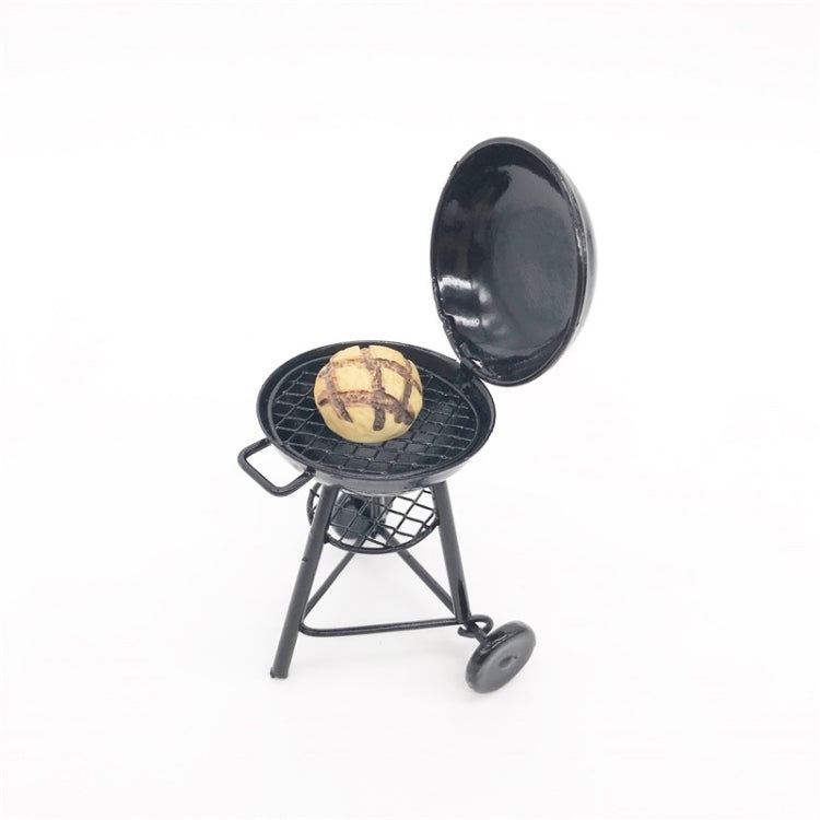 Mini round outdoor oven toy with food on wire grate, open lid, black metal