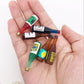 Mini wine drink bottle ornaments in a hand, small blue, red, green, amber bottle shapes.