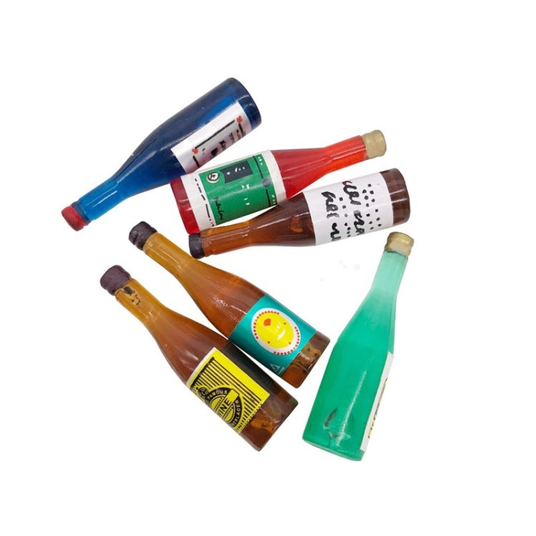 Mini wine drink bottle ornaments pile, assorted blue, red, brown, green bottle colors.