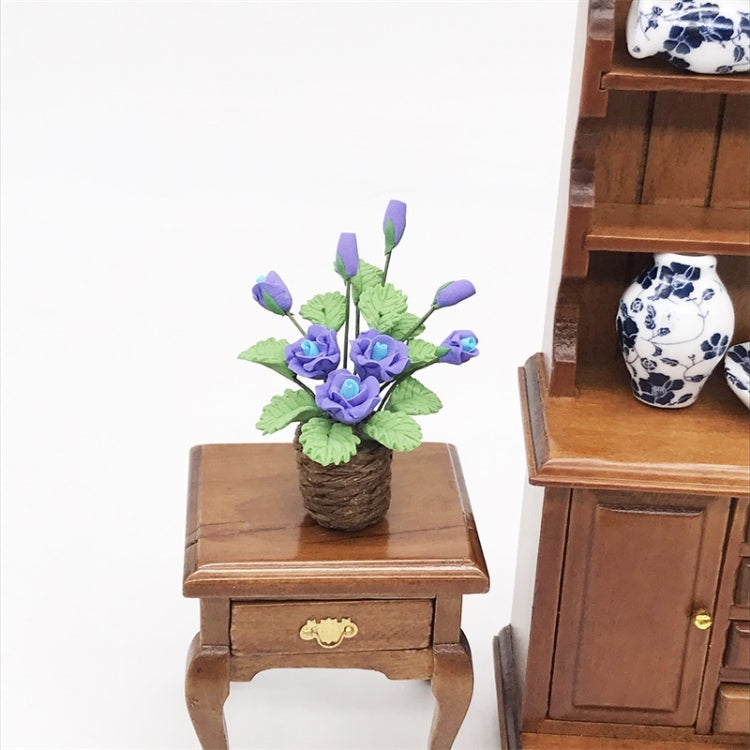 Purple rose flower model toy in brown pot on miniature wooden side table