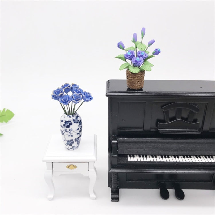 Purple rose flower model toy in brown pot on miniature black piano