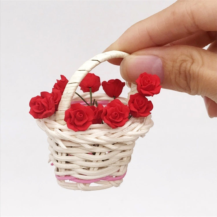 Mini dollhouse dark red roses in small woven basket, held by hand