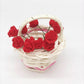 Mini dollhouse woven basket with dark red rose heads and green stems