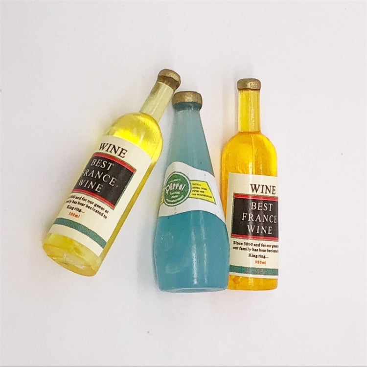 Three mini wine drink bottles with gold caps, yellow and blue drink colors
