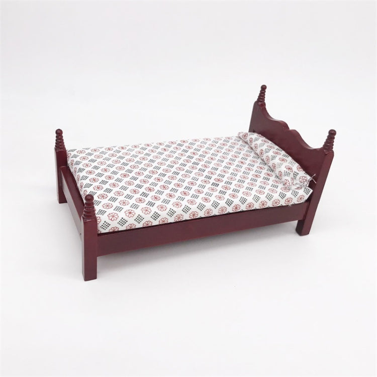 Mini dollhouse single bed toy shown at an angle; dark maroon frame, patterned white bedding