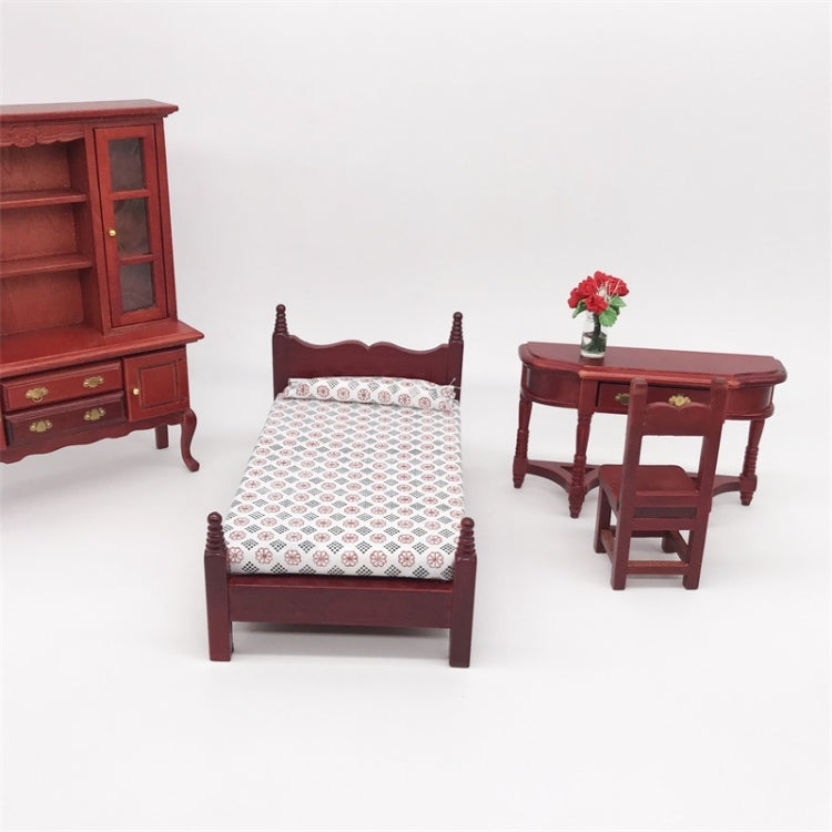 Mini dollhouse single bed toy with dark maroon posts and white patterned mattress