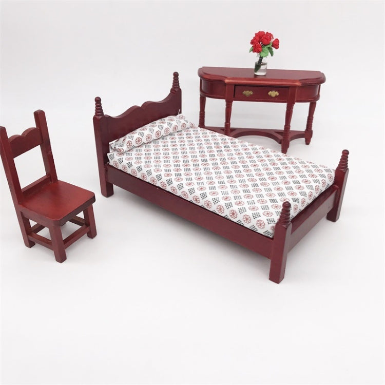 Mini dollhouse single bed toy with dark maroon headboard and white patterned quilted mattress