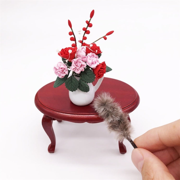 Mini chicken-hair simulation brush toy resting on red round table beside flower bouquet