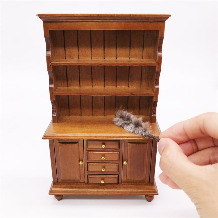 Mini chicken-hair simulation brush toy lying in open wooden cabinet drawer