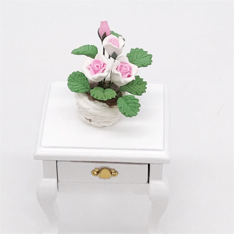 Mini potted rose ornament with pink-and-white flowers and green leaves on a white stand