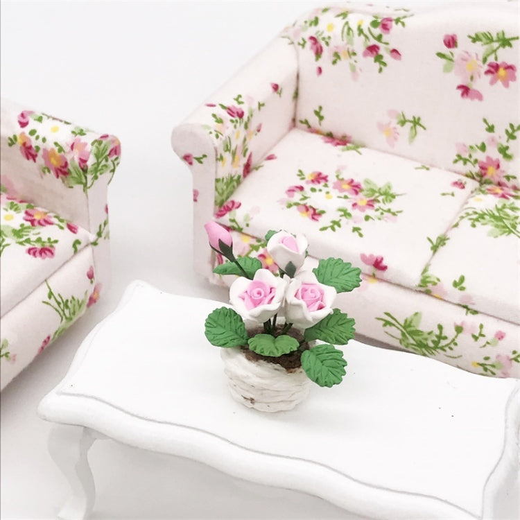 Mini potted rose ornament with pink-and-white blooms and green leaves in a white pot