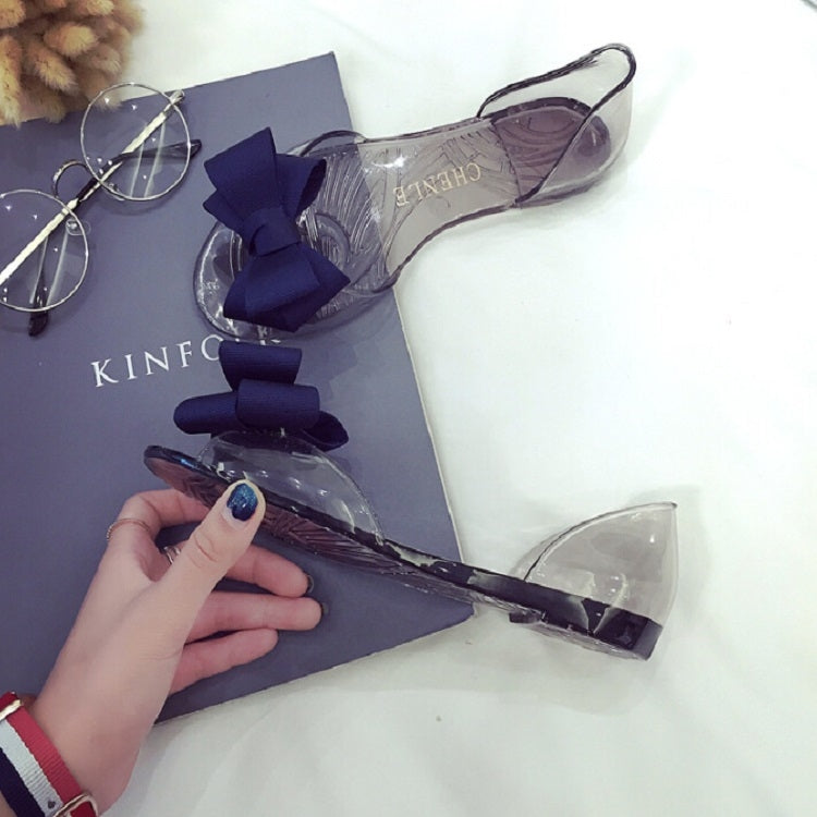Transparent jelly flats with navy bow accents, flat sole and open toe