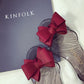 Transparent jelly flats with red fabric bows and open toe, side view