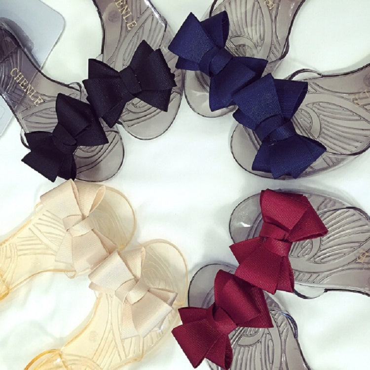 Transparent jelly flats with bows in navy, red, and light colors; open toe