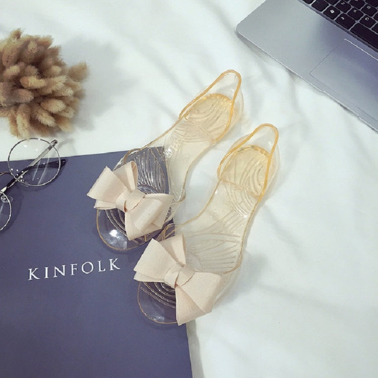 Transparent jelly flat shoes with cream bow, open toe and clear upper