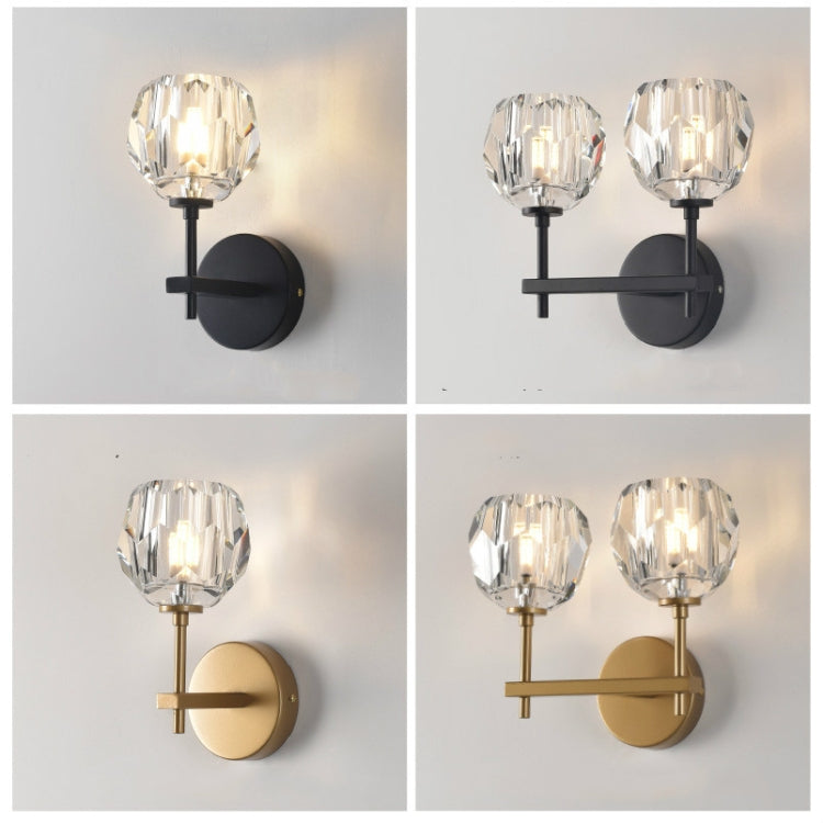 Wall sconce set showing black and gold crystal shades with round backplates