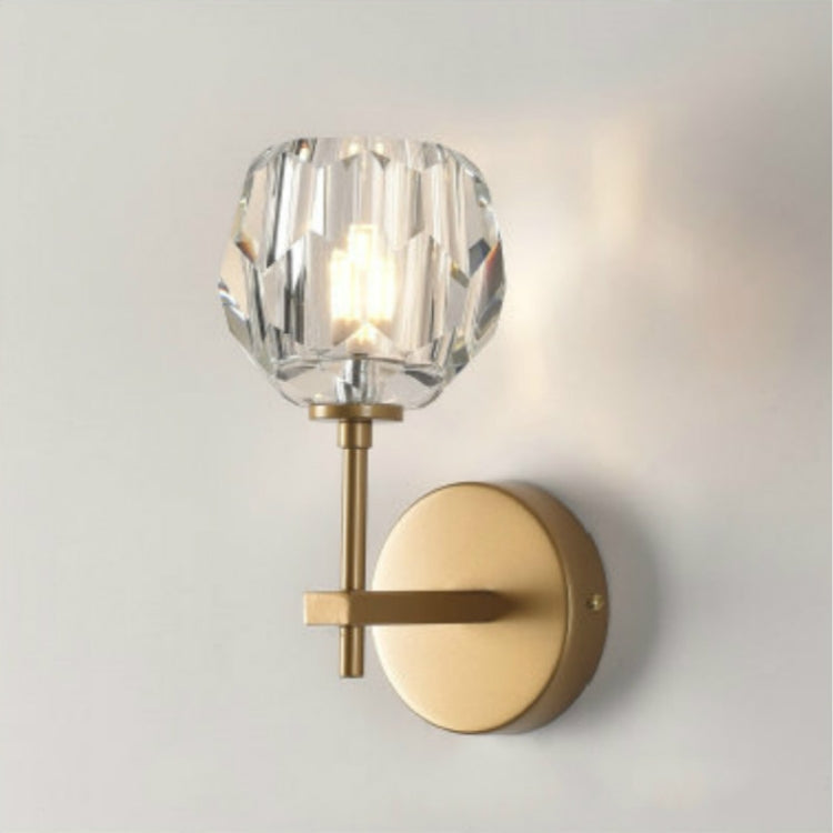 Gold wall lamp with faceted crystal shade and round wall plate