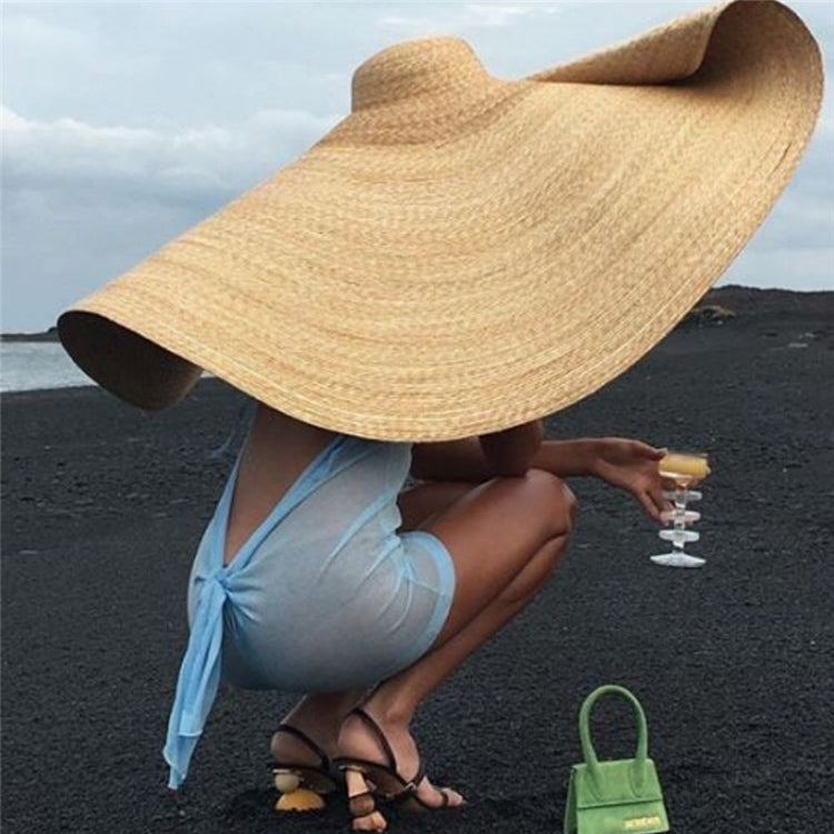 Beige woven straw sun hat with oversized flared brim