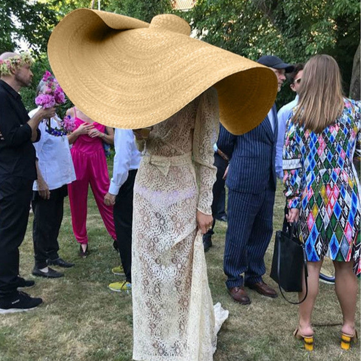 Wide beige woven straw sun hat with flared brim