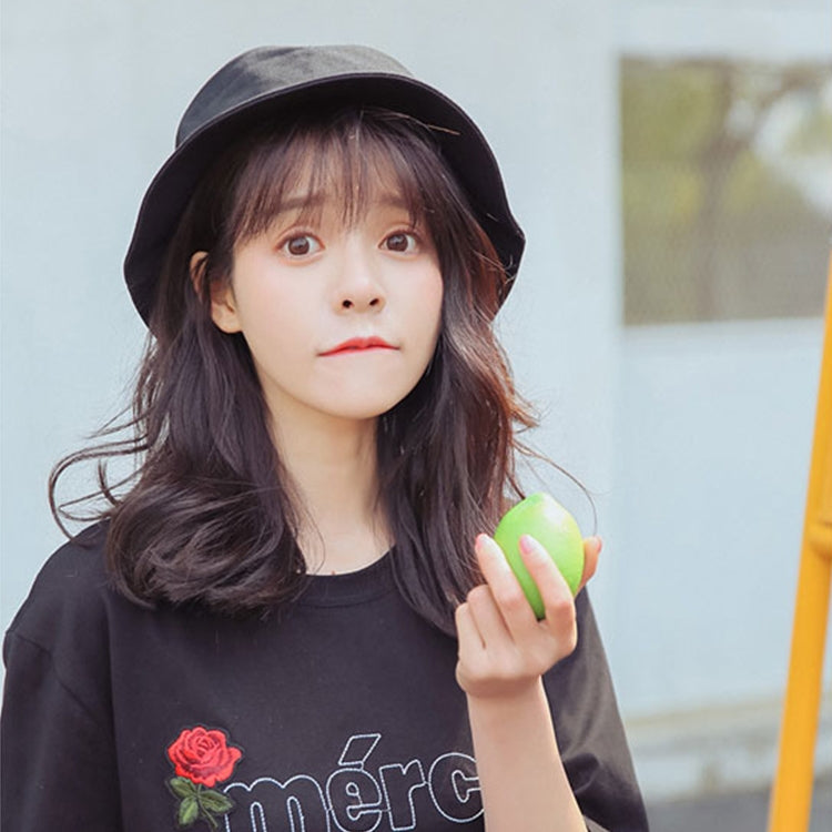 Black cotton fisherman bucket hat on head with wide brim