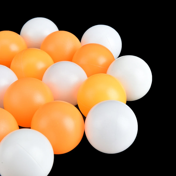 Seamed table tennis balls, orange and white, close-up cluster