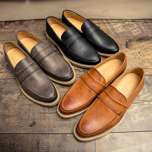 Assorted men’s slip-on loafers with pointed toes in black, gray, and brown, stitched soles