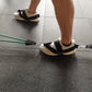 Black shoe cover pull-rope straps on sneakers, with pull rope handles and green bar