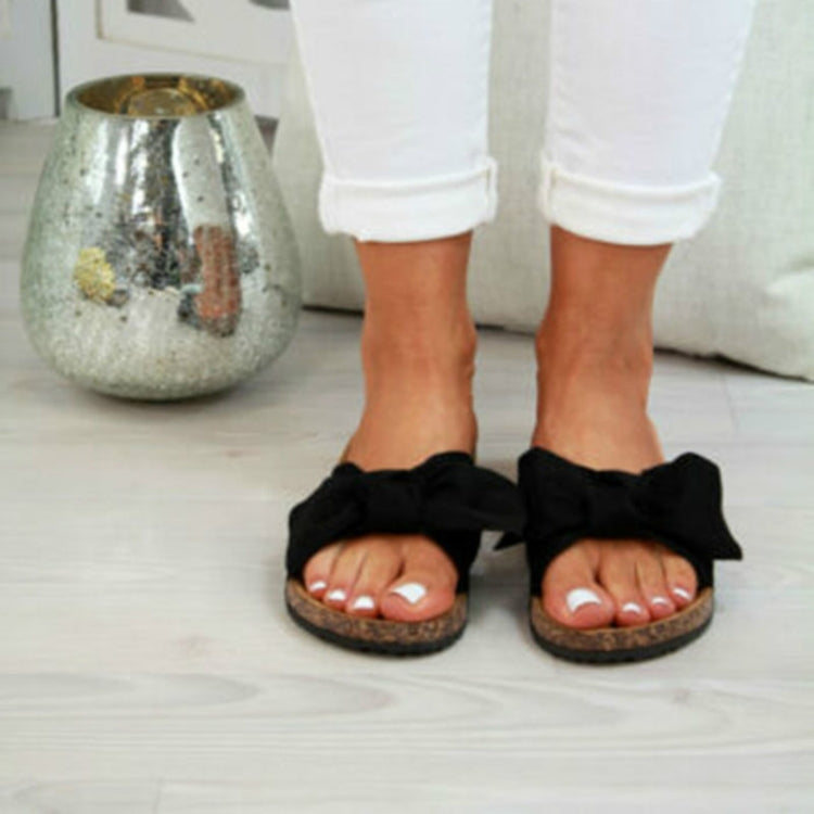 Women’s bow tie slippers in black, open-toe slide with textured sole