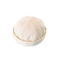 Light cream melon cap with adjustable strap and stitched crown seams