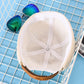 Light cream cotton-linen melon cap with stitched crown spokes and center button