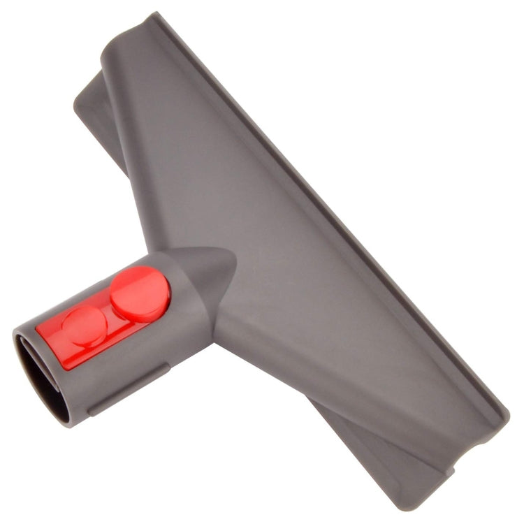 Gray vacuum suction head with red release button at joint