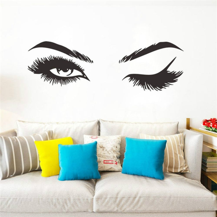 Black eye and eyebrow wall sticker set with two stylized eye decals above a sofa.