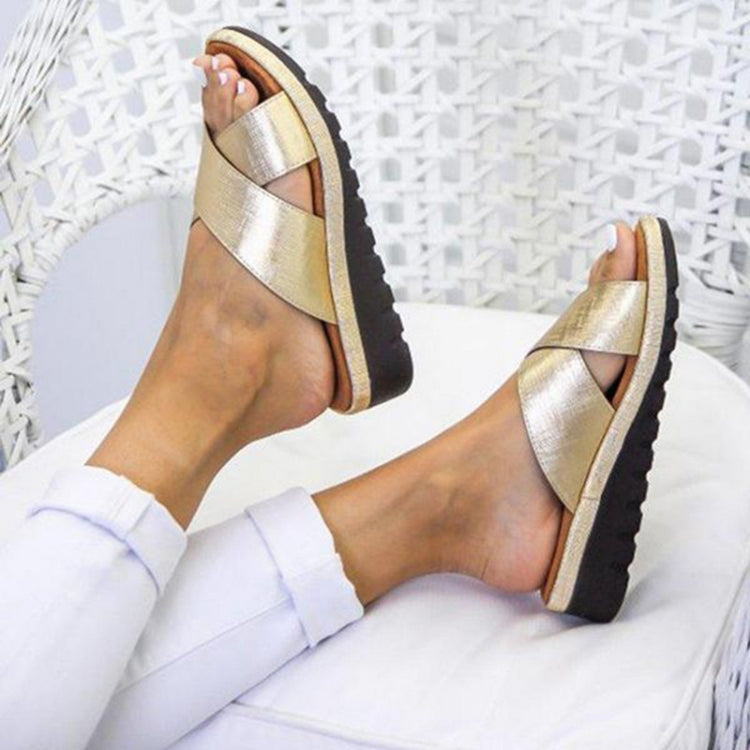 Women’s open-toe slip-on sandals with metallic gold straps and molded dark sole