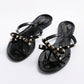 Black rhinestone bow thong flip-flops with flat sole and open-toe slip-on design