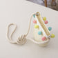 Girls mini woven satchel with braided strap and colorful pom-pom trim, beige