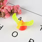 Balancing bird toy with lime green bird and red weighted base
