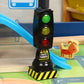 Toy traffic light standing on base with green, yellow, and red LED signals