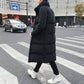 Men's black long puffer down coat back view, high collar, button closure, standing