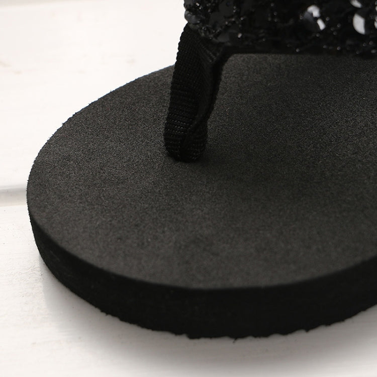 Black wedge flip-flop with fabric toe strap and cushioned platform sole