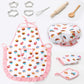 Kids chef play set with pink cupcake apron, chef hat, and small matching kitchen tools