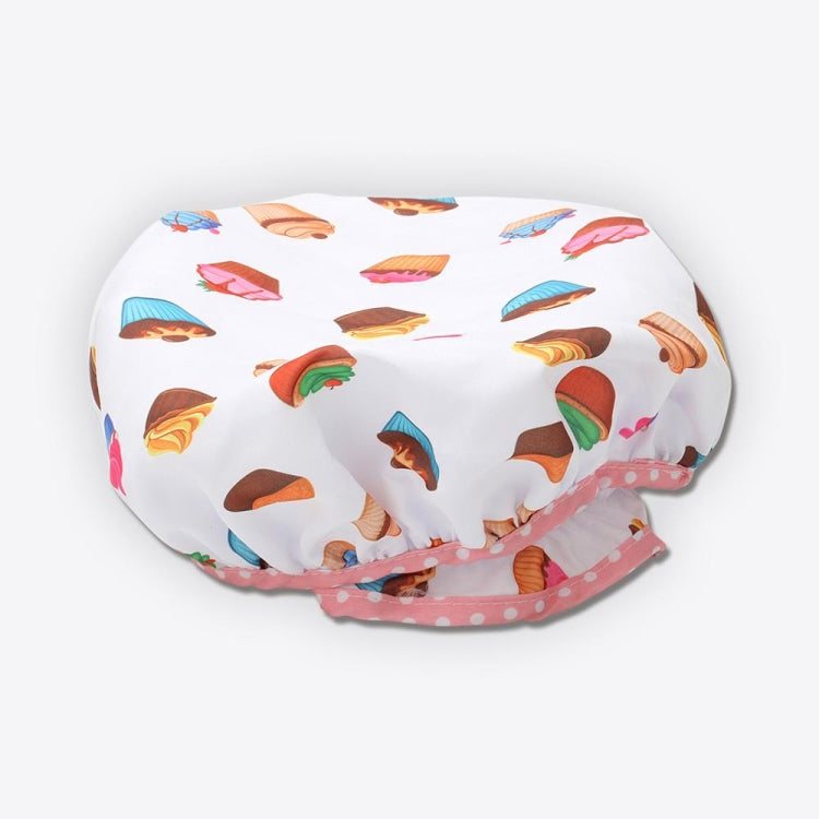 Kids chef hat with white fabric, colorful cupcake print, and pink dotted ruffle brim