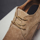 Men's brown suede oxford shoes close-up of lace-up vamp and seam details