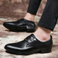Black pointed-toe lace-up dress shoes worn with cropped pants and low block heel