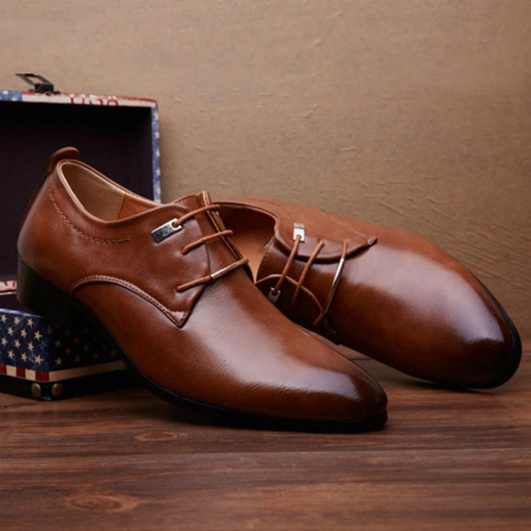Brown pointed-toe lace-up dress shoes with metal lace eyelets and low block heel