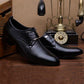 Black pointed-toe lace-up dress shoes with low block heel displayed indoors