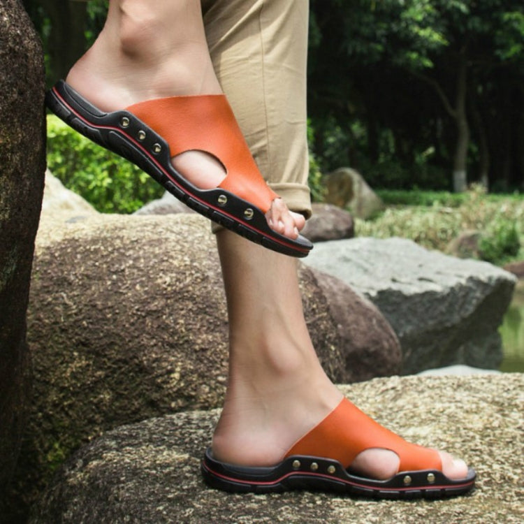 Men's orange slide sandals with open toe, perforated footbed, and studded straps