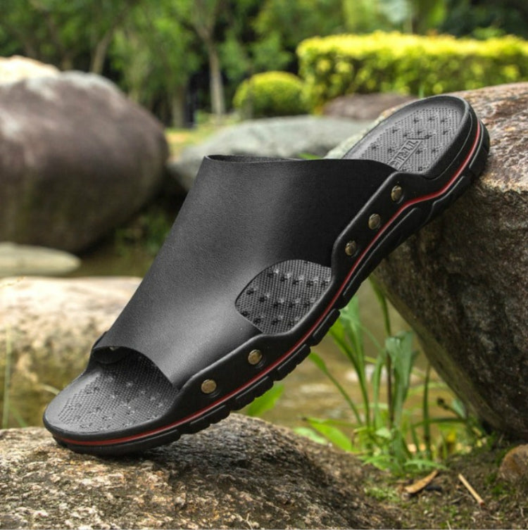 Men's black slide sandals with textured footbed and red trim on the sole