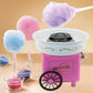 Pink retro cotton candy trolley machine with cotton candy on sticks and a white bowl heater.