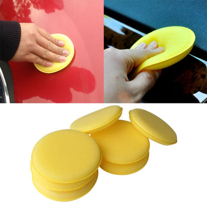 Yellow foam waxing pad sponge, held in hand for car detailing and soft wax application